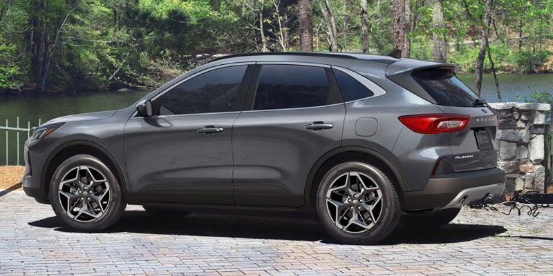 Grey Ford Escape parked beside a river