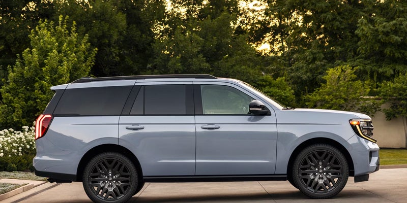 Ford Expedition parked outside a home at dusk