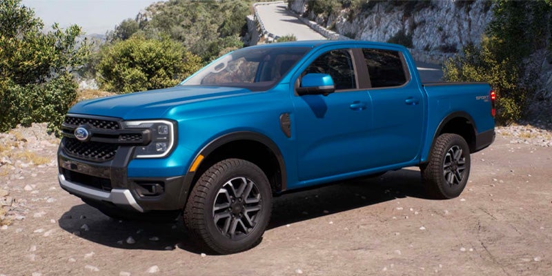 Blue Ford Ranger crew cab parked on a mountain road