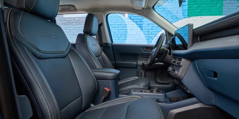 Car interior with blue-gray seats, yellow stitching, 