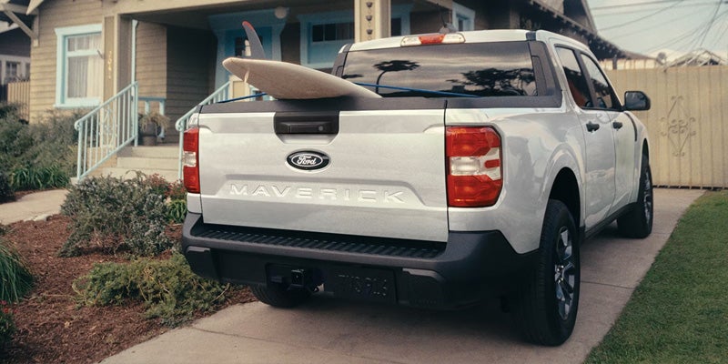 2026 Ford Maverick Hybrid pickup truck with surfboard in bed